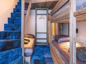 a bedroom with two bunk beds and a staircase at Chalet Haut de Gamme à Avoriaz - 11 Pers, Ski-in/Ski-out, Sauna, Terrasses Panoramiques, Service Premium - FR-1-314-114 in Morzine