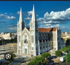 a large white church with two towers on top at flet para temporadas in Petrolina