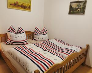 a bed with two pillows on top of it at Ferienwohnung Erika in Badenweiler