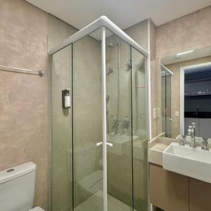 a bathroom with a shower and a toilet and a sink at Studios Prime Pivô Match - Jardins in Sao Paulo