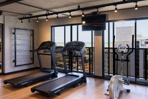 a gym with two tread machines in front of a window at Way Tambaú #C4 - Duplo deluxe by Carpediem in Tambaú