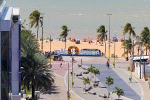 a view of a beach with palm trees and the ocean at Way Tambaú #C4 - Duplo deluxe by Carpediem in Tambaú