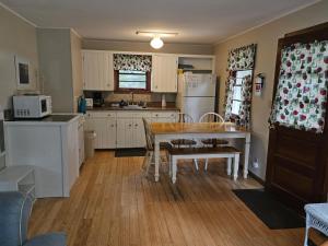 a kitchen with a table and a refrigerator at Brookhaven 4 in Maple City