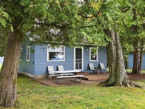 ein blaues Haus mit einem Picknicktisch davor in der Unterkunft Brookhaven 3 in Maple City