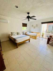 Ένα ή περισσότερα κρεβάτια σε δωμάτιο στο Aguacatl Cozumel