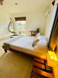 Ένα ή περισσότερα κρεβάτια σε δωμάτιο στο Aguacatl Cozumel