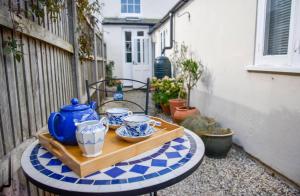 a table with a blue pot and bowls on it at The Sovereign in Whitstable
