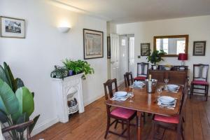 a dining room with a table and a fireplace at The Sovereign in Whitstable