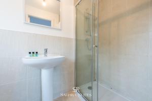 a bathroom with a sink and a shower at Stylish 3BED Glan Llyn Retreat - Close to Cardiff & Newport - Parking in Newport +24 photos