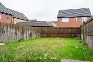 a wooden fence in a yard with houses at Stylish 3BED Glan Llyn Retreat - Close to Cardiff & Newport - Parking in Newport