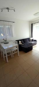 a living room with a couch and a table at Spí v Kuklenách 1 in Hradec Králové +1 photo