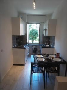 a kitchen with a table and chairs and a dining room at Sesto Marelli in Milan