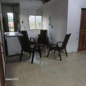 a group of chairs and a table in a room at Sítio Promessa in Benevides