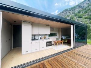 a kitchen and dining area of a house with a deck at Flåm Retreat in Aurland
