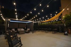 a patio with chairs and lights at night at Ramada by Wyndham Tukwila Southcenter in Tukwila