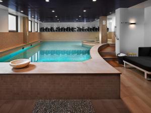 a large swimming pool in a hotel room at Sofitel Legend The Grand Amsterdam in Amsterdam +208 photos