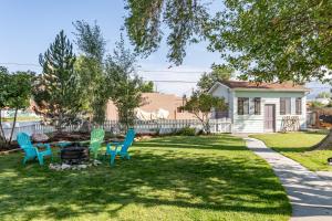 a yard with blue chairs and a fire pit at Bluebird Cottage, 1897 Home On Salida's Alpinepark in Salida