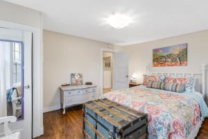 a bedroom with a large bed with a dresser and a bed sidx sidx sidx at Bluebird Cottage, 1897 Home On Salida's Alpinepark in Salida +37 photos