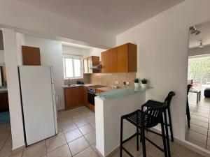 a kitchen with a counter and two stools in it at Spacious City Center - Suite 203 in Nicosia