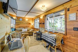 a kitchen and living room with a table and chairs at Outdoor Kitchen and Canal Views Cabin in Quilcene! in Seabeck