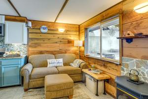 a living room with a couch and a table at Outdoor Kitchen and Canal Views Cabin in Quilcene! in Seabeck