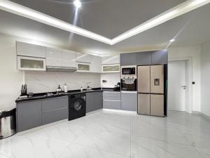 a large kitchen with stainless steel appliances in a room at Stunning 2 Bedroom Apartment Overlooking the Ocean in Dakar