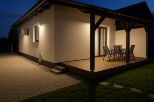 a rendering of a house with a deck at night at Heidi Apartman in Mezőkövesd
