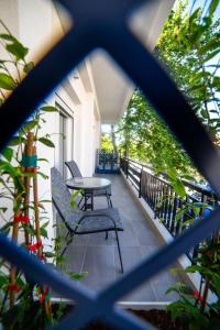 een balkon met een tafel en stoelen bij Coloris Rubrum room in Thessaloniki