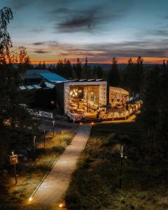 a view of a building with a sunset in the background at Arctic TreeHouse Hotel in Rovaniemi