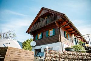 a wooden house with a balcony on top of it at Kröll-Hube in Sankt Johann im Saggautal