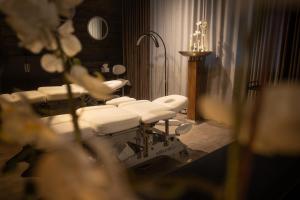 a row of white sinks in a bathroom at Arctic TreeHouse Hotel in Rovaniemi