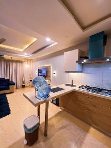 a kitchen with a table with a bag on it at OSMA Living Full Furnished Apartment In Islamabad in Rawalpindi
