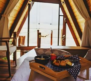 a tray of food on a table in a room at Cabana Zé da Lapinha - Passarela in Santana do Riacho