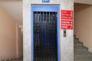 a blue door with a sign in front of it at Hotel O Prabha Palace Lodge in Guwahati