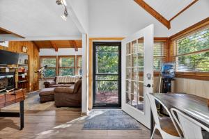 a living room with a door open to a living room at Mountain Escape with Games & Stargazing cabin in Basye