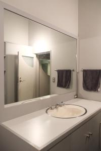 a bathroom with a sink and a large mirror at A rental house where you can stay in a residential - Vacation STAY 18763 in Honchō