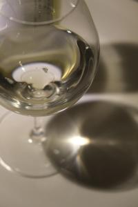 a glass of white wine sitting on top of a table at A rental house where you can stay in a residential - Vacation STAY 18763 in Honchō