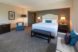 a hotel room with a bed and a chair at InterContinental Chicago Magnificent Mile by IHG in Chicago