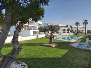 a villa with a swimming pool and trees at Apartment Orihuela Costa Golf 662 in Los Dolses