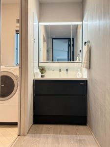 a bathroom with a sink and a washing machine at Akikawa Villas 15 - Vacation STAY 18848 in Fukumoto +25 photos