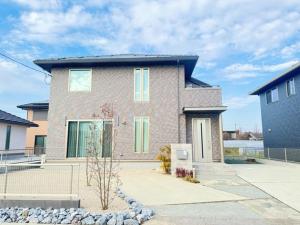 a large brick house with green shutters on it at Akikawa Villas 15 - Vacation STAY 18848 in Fukumoto
