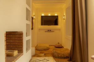 een hal met een kamer met een televisie aan de muur bij Riad Dar Ben Slimane in Marrakesh +80 foto's