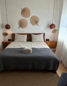 a bedroom with a bed with two towels on it at Wabi Sabi Retreat - 5 min from Palas of Culture in Iaşi
