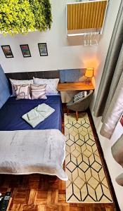 a bedroom with a bed and a table and a desk at Aconchego em congonhas- CGH in Sao Paulo +13 photos