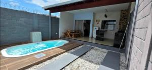 a hot tub sitting on a deck in a backyard at Cantinho Martins in Prado