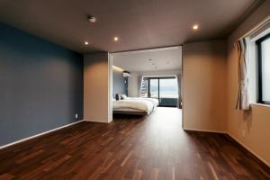 a bedroom with a bed and a large mirror at Kamogawa Sea Sauna Villa Kaito - Vacation STAY 08186v in Kamogawa