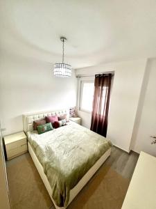 a bedroom with a bed and a window at Three above Sea apartment in Golem +54 photos