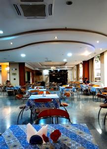 a restaurant with tables and chairs with blue and white tables at Hotel Presidente Asunción in Asunción