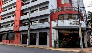 a red and white building on a city street at Hotel Presidente Asunción in Asunción
