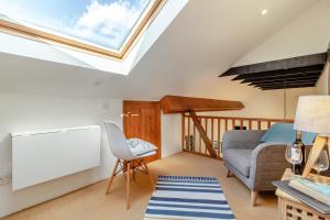 a living room with a skylight in the ceiling at Grove Barn in Langham +15 photos